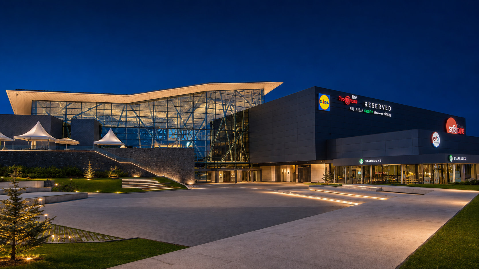 Осветеният площад пред Sofia Ring Mall в син час